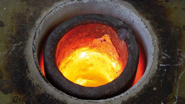 An ENRX induction furnace at work. This graphite crucible contains molten brass.    